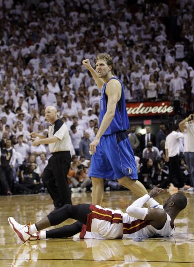 Mavericks’ Dirk Nowitzki pumps his fist over Miami Heat’s Dwyane Wade as Dallas ties finals at 1-1. (Associated Press)