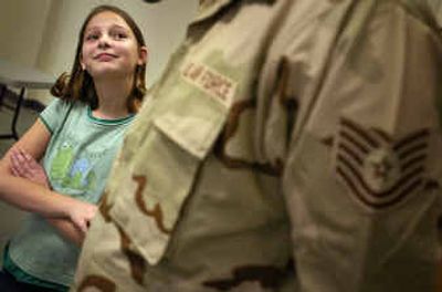 
Samantha Kelley, 10, looks to her father, Tech. Sgt. James Kelley, during a press conference before the deployment of 50 members of the 92nd Civil Engineer Squadron on Christmas Day to Asia. 
 (Jed Conklin / The Spokesman-Review)