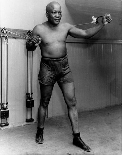 In this 1932 file photo, boxer Jack Johnson, the first black world heavyweight champion, poses in New York City. (Associated Press)