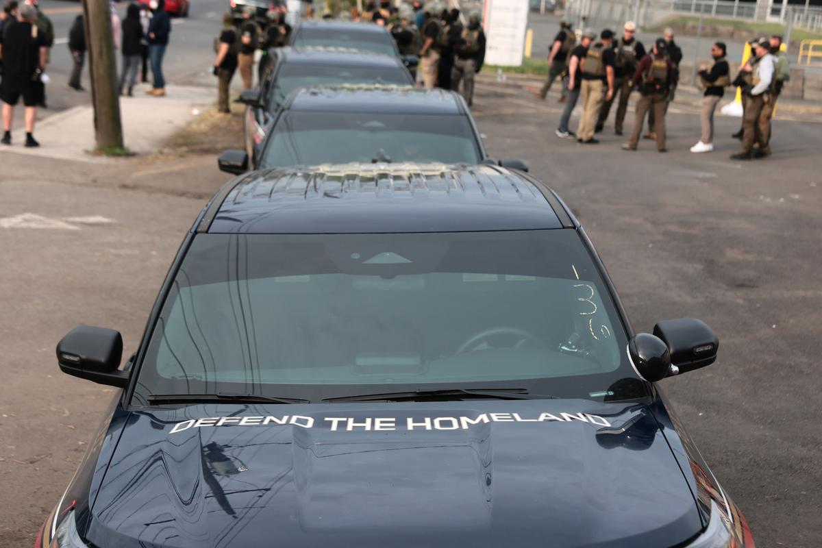 Immigration and Customs Enforcement vehicles are parked as agents stand guard in front of protesters outside Delaney Hall, which is being used as an Immigration and Customs Enforcement detention center, on May 27, 2026 in Newark, New Jersey. The Washington state Department of Licensing has refused to issue confidential license plates to some federal law enforcement agencies that conduct immigration enforcement, according to a lawsuit filed in federal court Thursday.  (Michael M. Santiago/Getty Images)