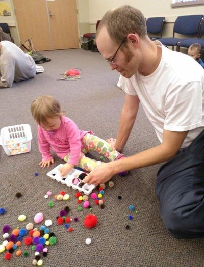 Anna and John Edmondson sort pom-poms at the North Spokane Library during a recent Love Talk Play program offered by the Spokane County Library District.