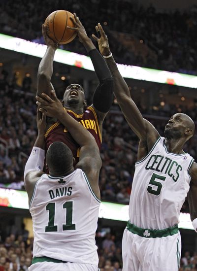 Cavaliers’ J.J. Hickson shoots over Glen Davis and Kevin Garnett.  (Associated Press)