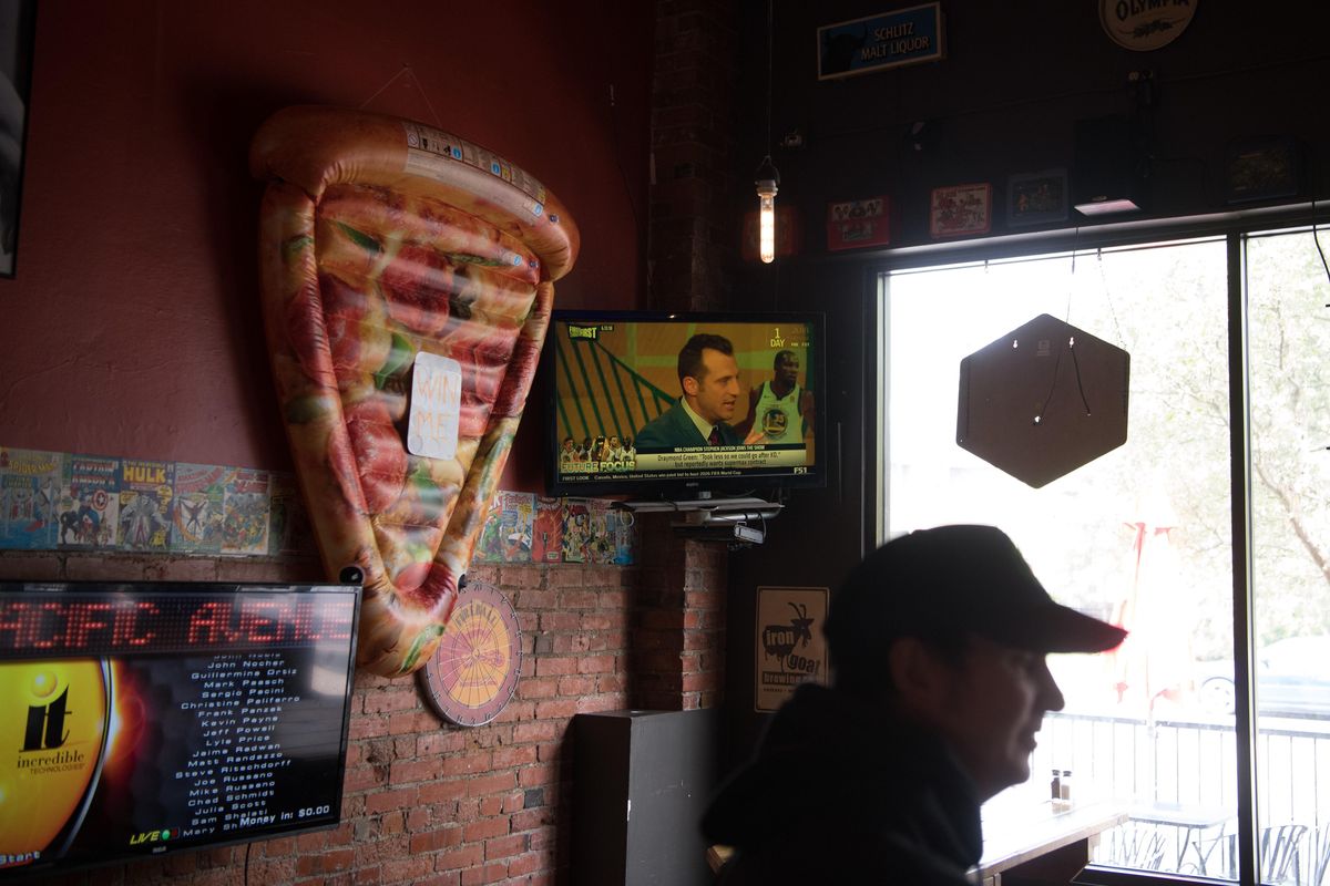 Ben Carter, manager of Pacific Ave Pizza, waits on customers on Wednesday in Spokane. (Tyler Tjomsland / The Spokesman-Review)