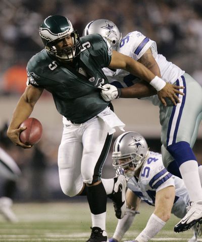 Linebacker Anthony Spencer wraps up Eagles quarterback Donovan McNabb in Dallas’ victory Sunday. (Associated Press)