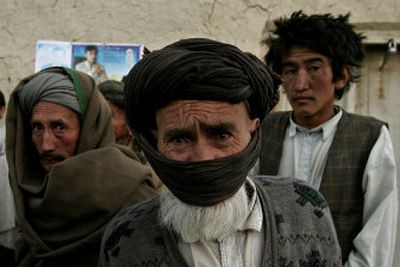 
Ethnic Hazara people watch a convoy arriving with elections materials in the village of Sare Dare Shasht, in Bamiyan province, central Afghanistan, on Friday. 
 (Associated Press / The Spokesman-Review)