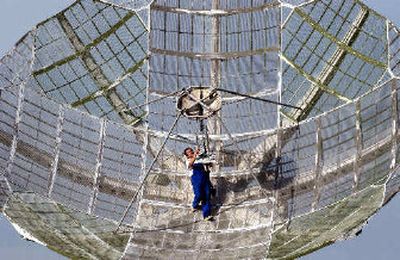 
A technician from the Czech Academy of Sciences Ionosferic and Telemetric Observatory in Panska Ves, North Bohemia, Czech Republic, adjusts a parabolic antenna to receive signals from world's first solar sail spacecraft, Cosmos 1, on Tuesday. 
 (Associated Press / The Spokesman-Review)
