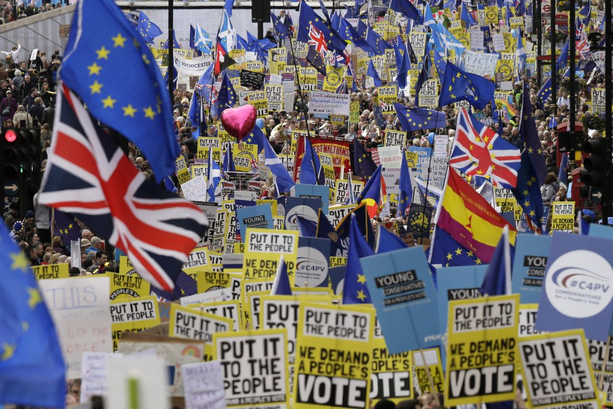 Demonstrators carry posters and flags during a Peoples Vote anti-Brexit march Saturday in London. (Tim Ireland / Associated Press photos)