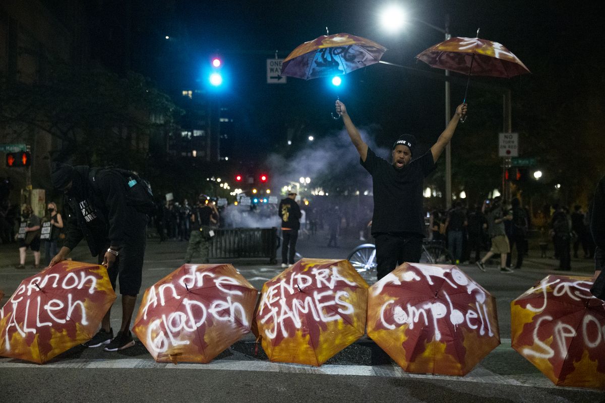 Umbrellas bearing the names of people killed by police were displayed at SW 3rd and Main as Portland protesters gather downtown on Friday, July 10, 2020.  (Dave Killen)