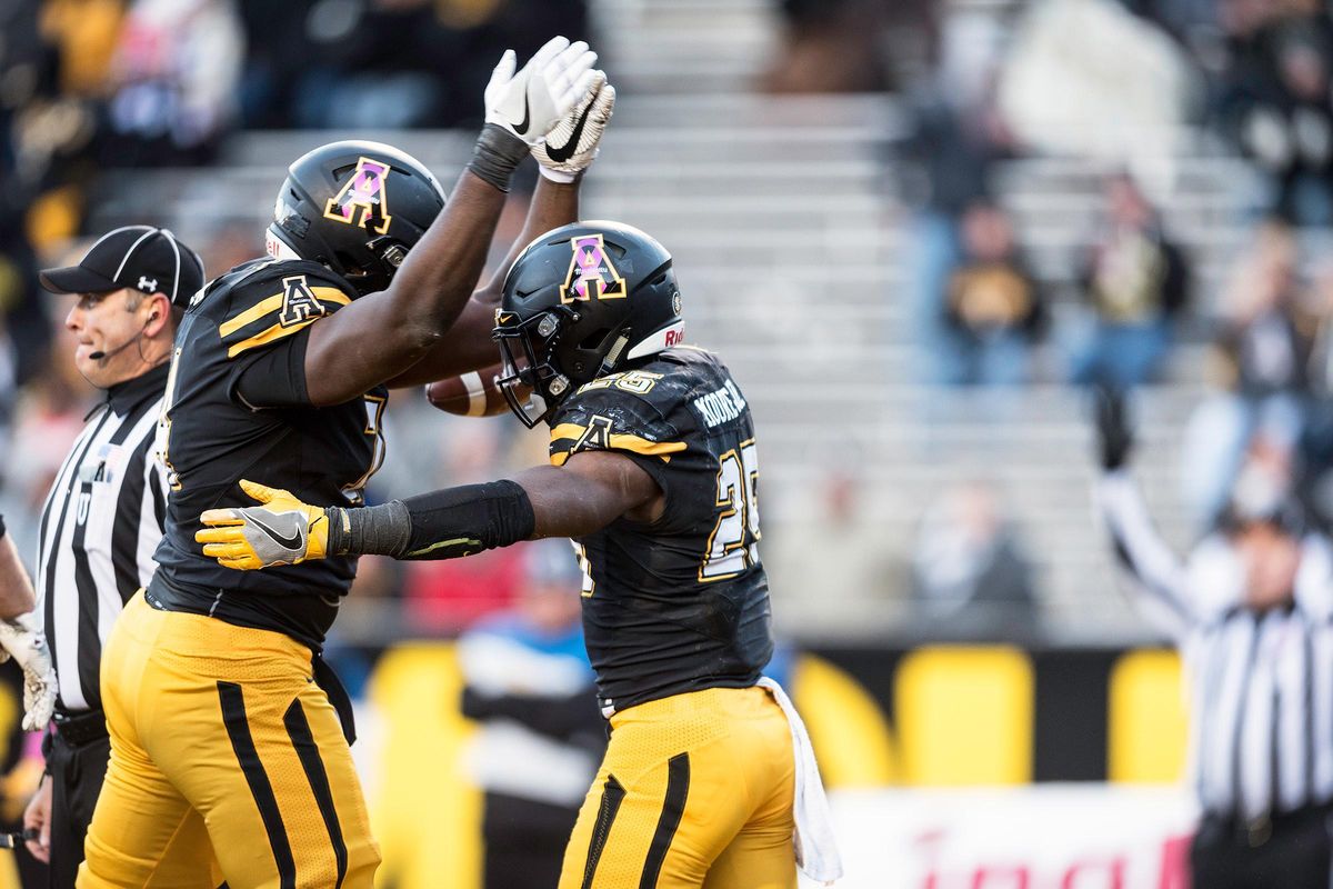 Appalachian State running back Jalin Moore, right, celebrates his touchdown with teammate Victor Johnson, during an NCAA college football game against Idaho on Saturday, Oct. 22, 2016, in Boone, N.C. (Allison Lee Isley / Winston-Salem Journal via AP)