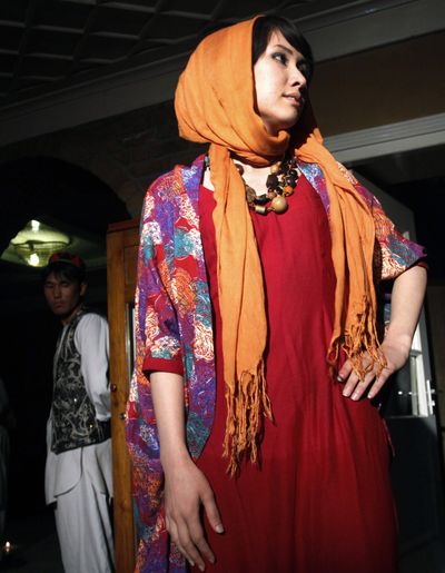 An Afghan model walks wearing a dress creation by Shahar Banoo Zeerak, organizer of a fashion show in Kabul, Afghanistan, on Friday. (Associated Press)