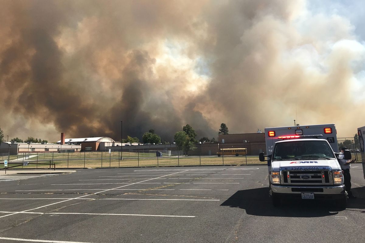 The smoke of a wildfire is seen over Medical Lake High School in Medical Lake, Washington, on Friday, Aug. 18, 2023.  (Colin Tiernan/THE SPOKESMAN-REVIEW)