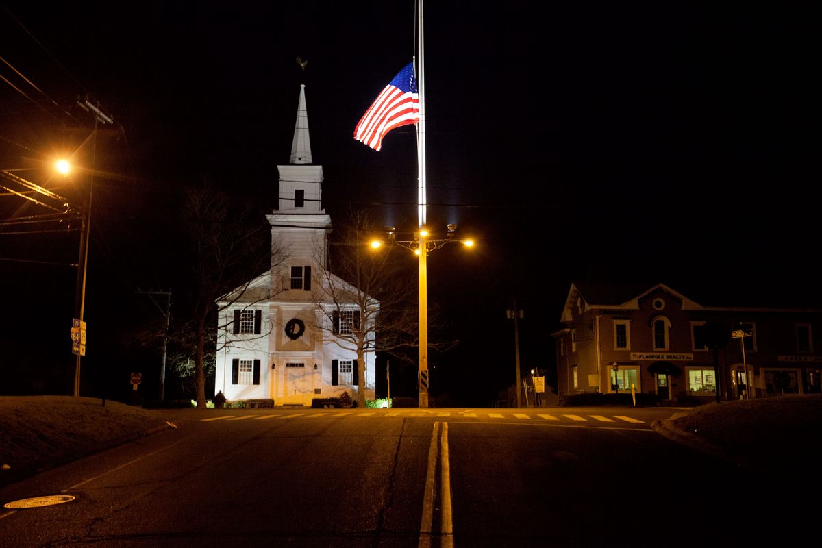 A U.S. flag flies at half-staff on Main Street in honor of the people killed when a gunman opened fire inside a Connecticut elementary school, Saturday, Dec. 15, 2012, in Newtown, Conn. (David Goldman / Associated Press)