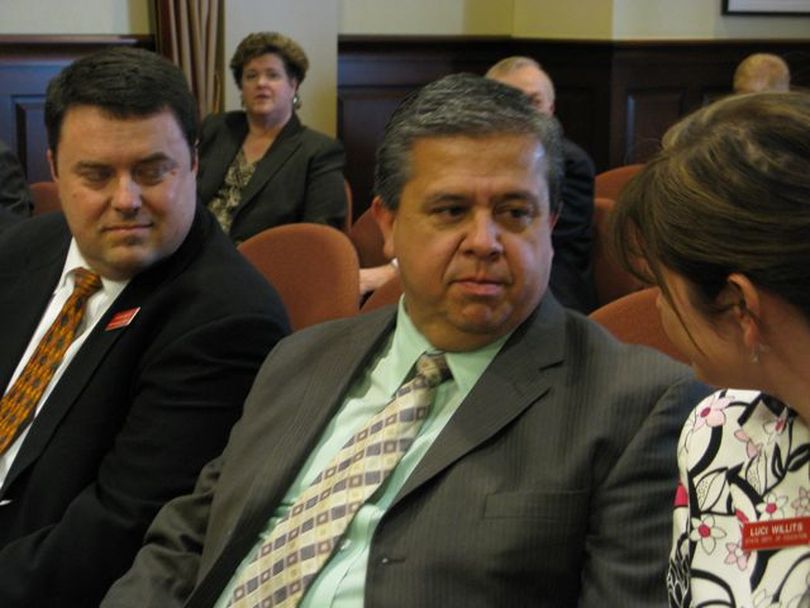 Idaho state schools Supt. Tom Luna, center, confers with his chief of staff, Luci Willits, before the Senate Education Committee takes up his final school reform bill on Tuesday; at left is Luna aide Jason Hancock, who drafted the bill. (Betsy Russell)