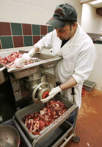 
Butcher Nehme Mansour grinds halal meat at a market in Michigan. While there are 400 kosher certification agencies in the United States, there are only about a half-dozen halal certifiers, according to market researcher Mintel International Group.
 (The Spokesman-Review)