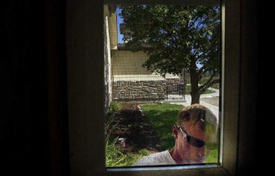 
Andrew Johnson paints trim on the newly dedicated Teen Challenge house in Airway Heights. Johnson and about 25 other men live in the house. 
 (Jed Conklin / The Spokesman-Review)