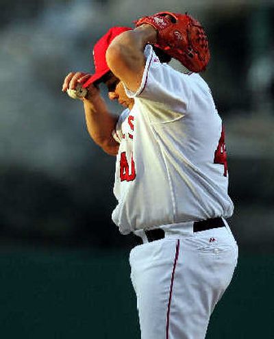 
Angels starter Bartolo Colon pauses after allowing four first-inning runs to Seattle. 
 (Associated Press / The Spokesman-Review)