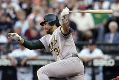 
Oakland's Mike Piazza singles in a run against Seattle during the first inning Thursday. Associated Press
 (Associated Press / The Spokesman-Review)