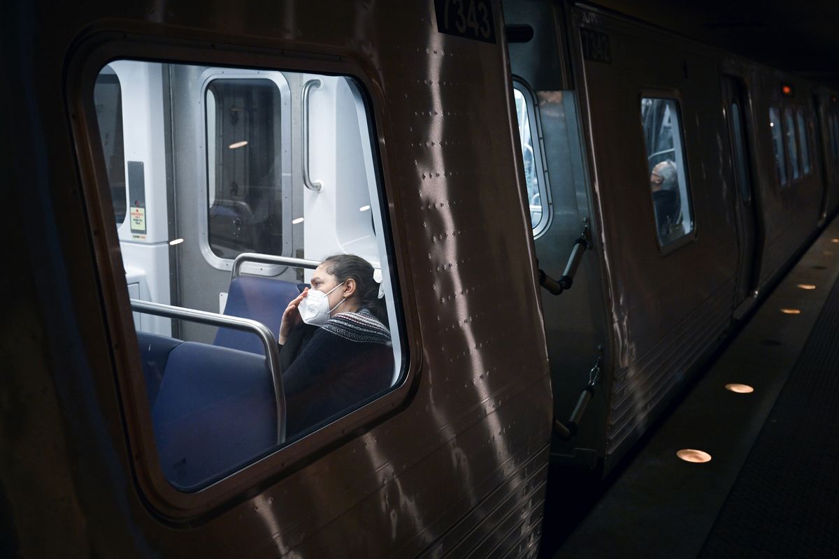 A passenger wears a mask in January at the Metro Center station. The CDC