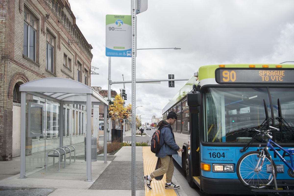 A passenger gets on an STA bus at the East Sprague Avenue bus stop at Napa Street Friday, Oct. 20, 2017. Buses stop in the lane of travel in the newly-completed traffic improvements on the stretch of Sprague that includes stops at Madelia and Napa. To minimize dwell time which blocks traffic, buses will now use both front and rear doors to load quickly during busy periods. (Jesse Tinsley / The Spokesman-Review)