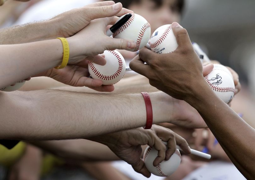 ORG XMIT: FLJR116 New York Mets pitcher Francisco Rodriguez hands a ball back to an autograph seeker during spring training baseball Sunday, Feb. 15, 2009, in Port. St. Lucie, Fla. (AP Photo/Jeff Roberson) (Jeff Roberson / The Spokesman-Review)