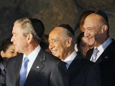 
President Bush, Israeli Prime Minister Ehud Olmert, right, and Israel's President Shimon Peres toured the Yad Vashem Holocaust Memorial in Jerusalem on Friday. Associated Press
 (Associated Press / The Spokesman-Review)
