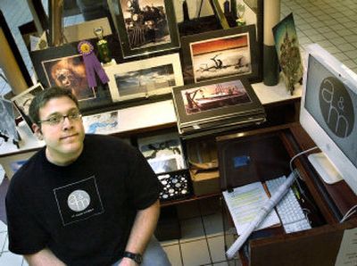 
Seth Everts, owner of Art, Music and More at Spokane Valley Mall is shown at his kiosk. The business features art of all forms from local and independent artists. Everts will be moving his business into a storefront  in the mall in November. 
 (Joe Barrentine / The Spokesman-Review)