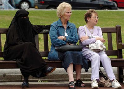 
Three women share a bench Sunday in Glasgow, Scotland, during a vigil for victims of the London bombings. 
 (Associated Press / The Spokesman-Review)
