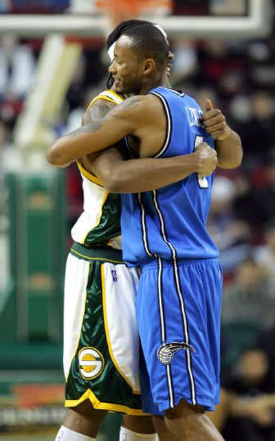 
Seattle's Chris Wilcox, left, hugs Orlando's Rashard Lewis on his return to town. Associated Press
 (Associated Press / The Spokesman-Review)