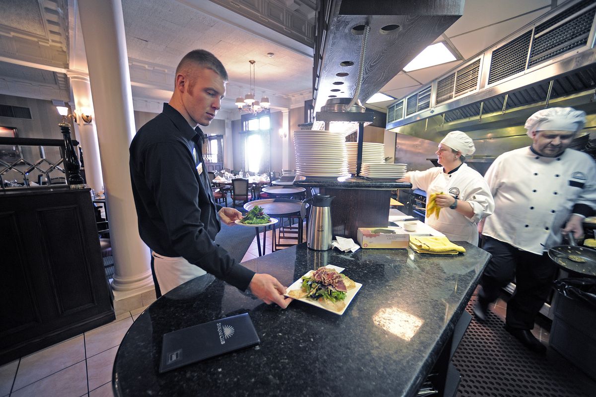 Waiter Joel Thomas prepares to serve an ahi tuna salad in the Spokane Club dining room in 2011.  (FILE/The Spokesman-Review)