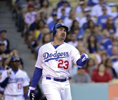 Adrian Gonzalez watches his three-run home run hit on second pitch as a Dodger. (Associated Press)