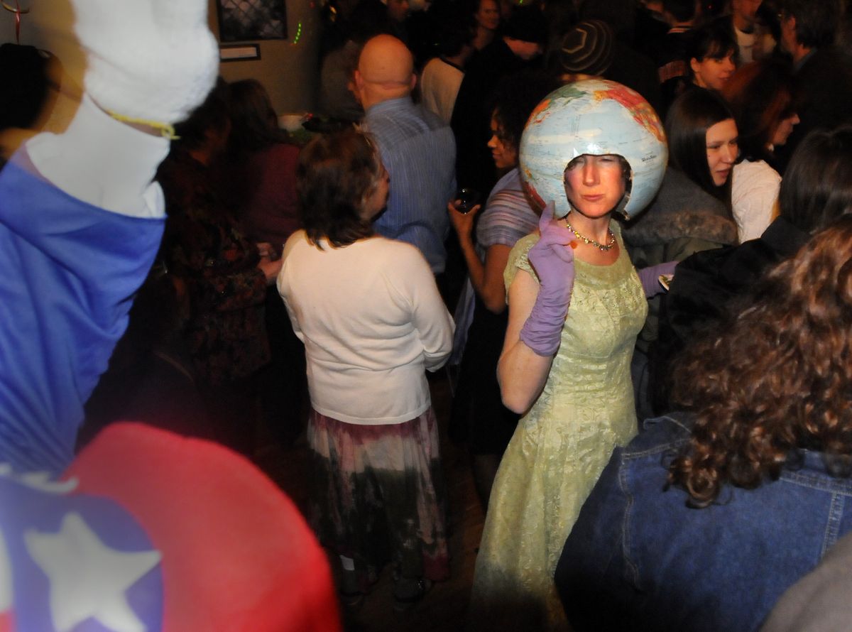 Patty Ratcliffe  wears a globe on her head and dances with other merrymakers at a party to celebrate President Obama’s inauguration Tuesday night  at the Community Building in Spokane. Ratcliffe said she was dressed as Mother Earth. “I’m celebrating a president who loves me,” she said. (Jesse Tinsley / The Spokesman-Review)