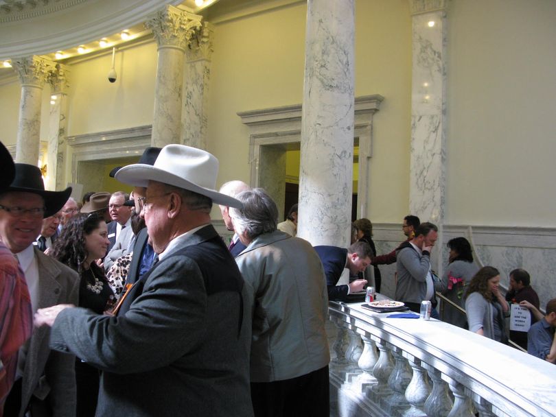 Idaho Cattle Association members in cowboy hats mix with 