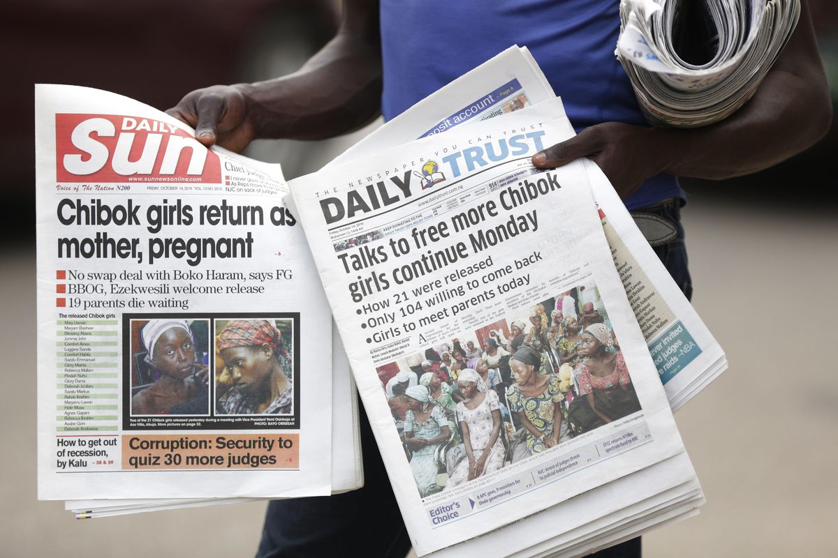 A newspaper vendor sells newspapers reporting on the release of some of the Chibok school girls, in Abuja, Nigeria, Friday, Oct. 14, 2016. (Sunday Alamba / AP)