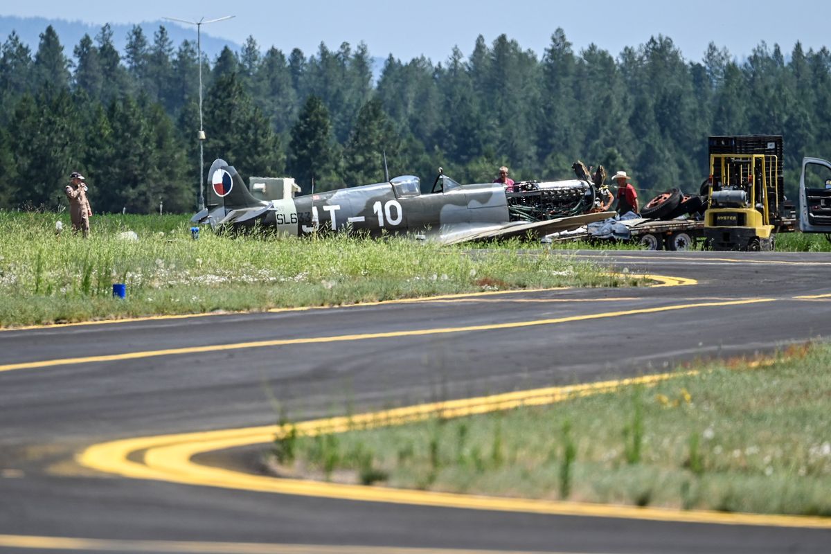 Historic Flight Foundation Chairman John Sessions watches the Supermarine Spitfire fighter being towed after a troubled landing, Friday, July 7, 2023 at the Deer Park Airport. He was uninjured. The Spitfires were used by the British and had a decisive advantage fighting the German Luftwaffe in the Battle of Britain.  (DAN PELLE/THE SPOKESMAN-REVIEW)
