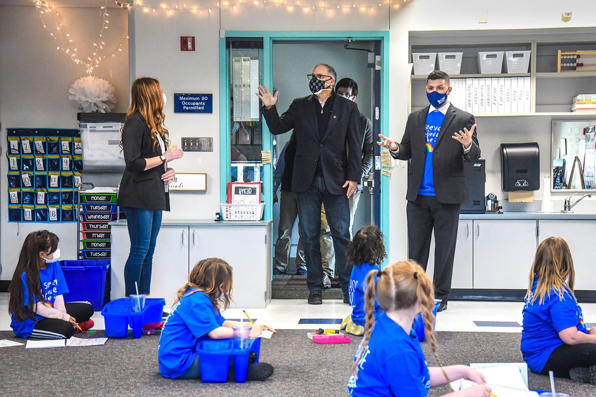 Gov. Jay Inslee, center, and Stevens Elementary School Principal Adrian Espindola, right, enter Daniele Bower’s first and second grade class, during a tour, Tuesday, Feb. 23, 2021, in Spokane.  (DAN PELLE/THE SPOKESMAN-REVIEW)