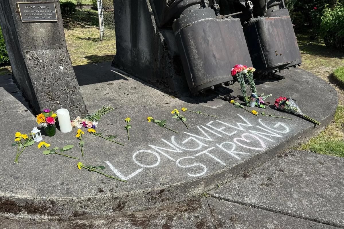 A memorial is set up for victims of the Longview mill implosion on Thursday outside the Nippon Dynawave Packaging plant.  (Shauna Sowersby/Seattle Times)