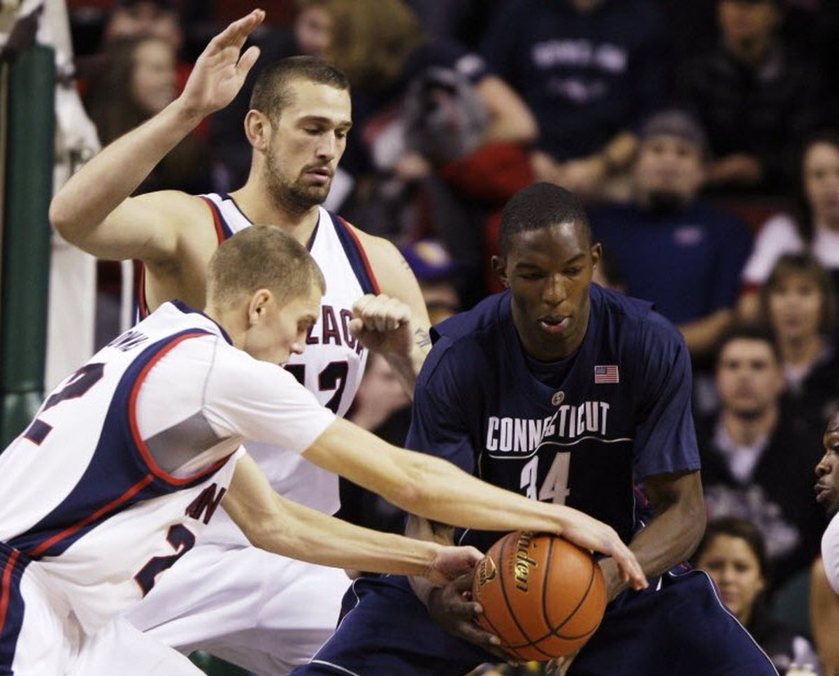 Gonzaga guard Micah Downs, left, steals the ball from Connecticut center Hasheem Thabeet, of Tanzania, right, as Gonzaga