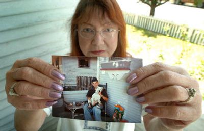 
Linda Dunham holds a photo of her son, Ryan Rasberry, and one of his dogs, Charlie, on Monday.  Rasberry's two dogs were recently euthanized at SpokAnimal. 
 (Joe Barrentine / The Spokesman-Review)