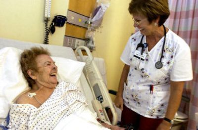 
Respiratory therapist Jean Schneider jokes with patient Ann Lamare after giving her a treatment Thursday at Kootenai Medical Center. 
 (Jesse Tinsley / The Spokesman-Review)
