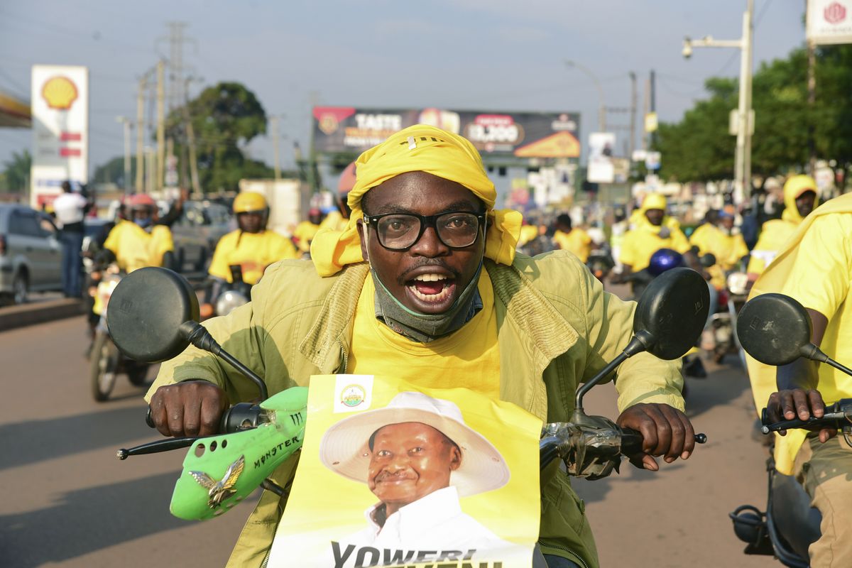 A supporter of Ugandan President Yoweri Kaguta Museveni celebrates in Kampala, Uganda, Saturday Jan. 16, 2021, after their candidate was declared winner of the presidential elections. Uganda’s electoral commission says longtime President Yoweri Museveni has won a sixth term, while top opposition challenger Bobi Wine alleges rigging and officials struggle to explain how polling results were compiled amid an internet blackout. In a generational clash widely watched across the African continent, the young singer-turned-lawmaker Wine posed arguably the greatest challenge yet to Museveni.  (Nicholas Bamulanzeki)