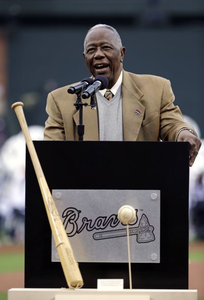 Hank Aaron speaks at 40th anniversary ceremony with the bat he used to hit his 715th home run on display. (Associated Press)