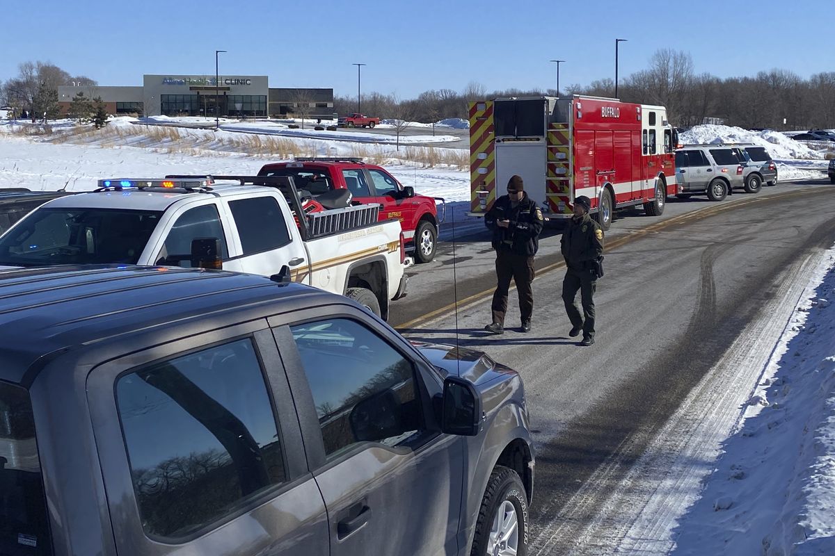 Law enforcement personnel and first responders gather outside of the Allina Health clinic, Tuesday, Feb. 9, 2021, in Buffalo, Minn. Authorities say multiple people were shot at the Minnesota health clinic on Tuesday and someone was taken into custody afterward.  (David Joles)