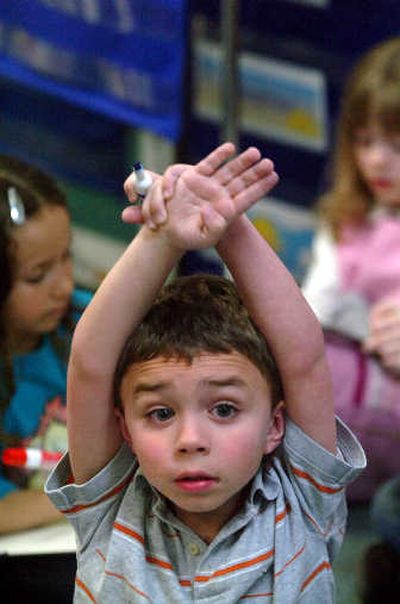 
Tanner McCabe raises his hand to answer a question during spelling practice at all-day kindergarten at Logan Elementary. The Washington Legislature approved 