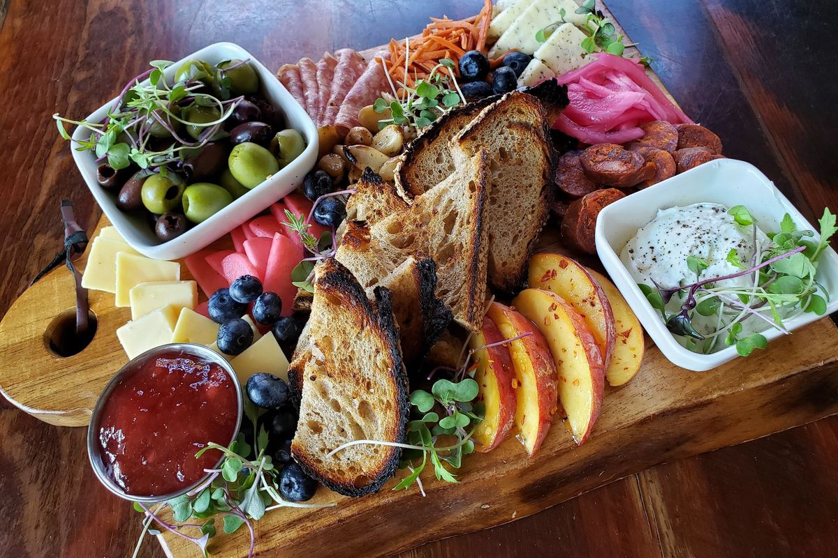 Charcuterie traditionally means cold cured meats but has become a moniker for grazing boards with a variety of cheeses, nuts, crackers and more.  (Hailey Bell)