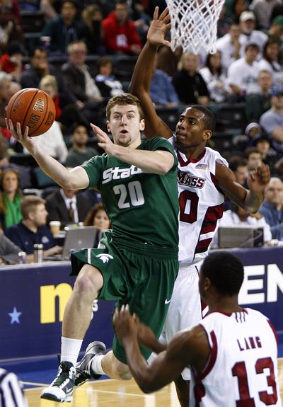 Michigan State’s Mike Kebler goes to the net with Massachusetts’ Javorn Farrell on his heels during the Spartans’ 106-68 win. (Associated Press)