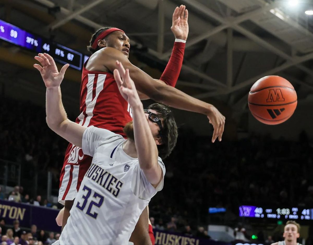 Former Washington State forward Isaac Jones blocks a shot attempt by Washington forward Wilhelm Breidenbach during a game last season at Alaska Airlines Arena in Seattle.  (Kevin Clark/Seattle Times)