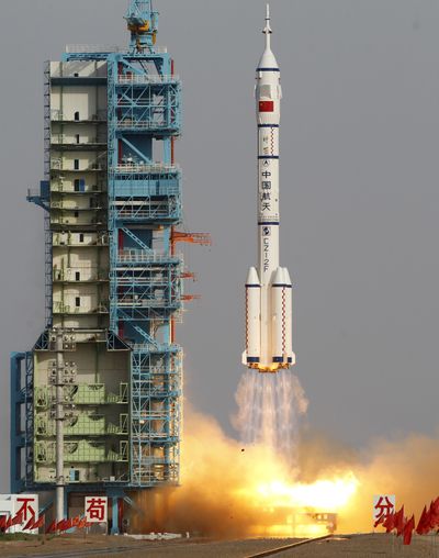 The Shenzhou 9 rocket lifts off from the launch pad at the Jiuquan Satellite Launch Center on Saturday. (Associated Press)