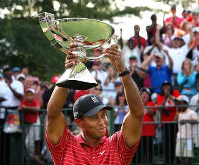 
Tiger Woods holds the FedEx Cup trophy aloft after completing Sunday's round.Atlanta Journal-Constitution
 (Atlanta Journal-Constitution / The Spokesman-Review)