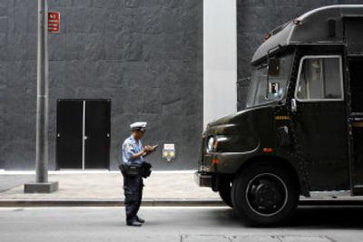 
Officer Md  Halim writes a ticket for a UPS truck in a 