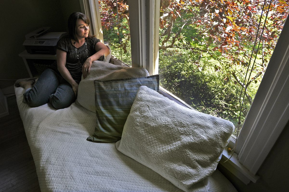 Ashley Potter looks out onto the world from her home office. Potter has put together a show of her photographic images of local children with autism that will be shown at the Kress Gallery in River Park Square.  (Christopher Anderson)